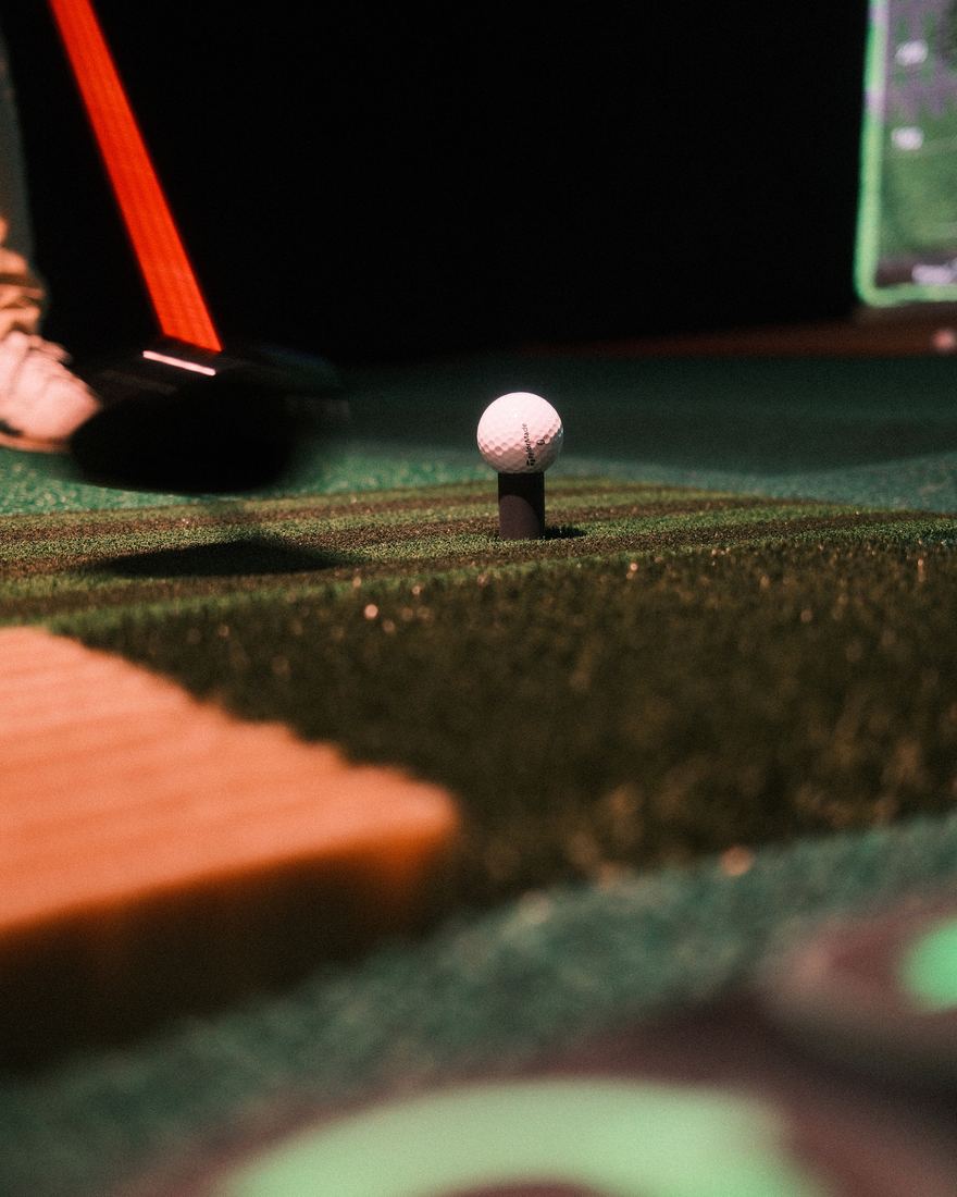Golf ball on a tee, low angle