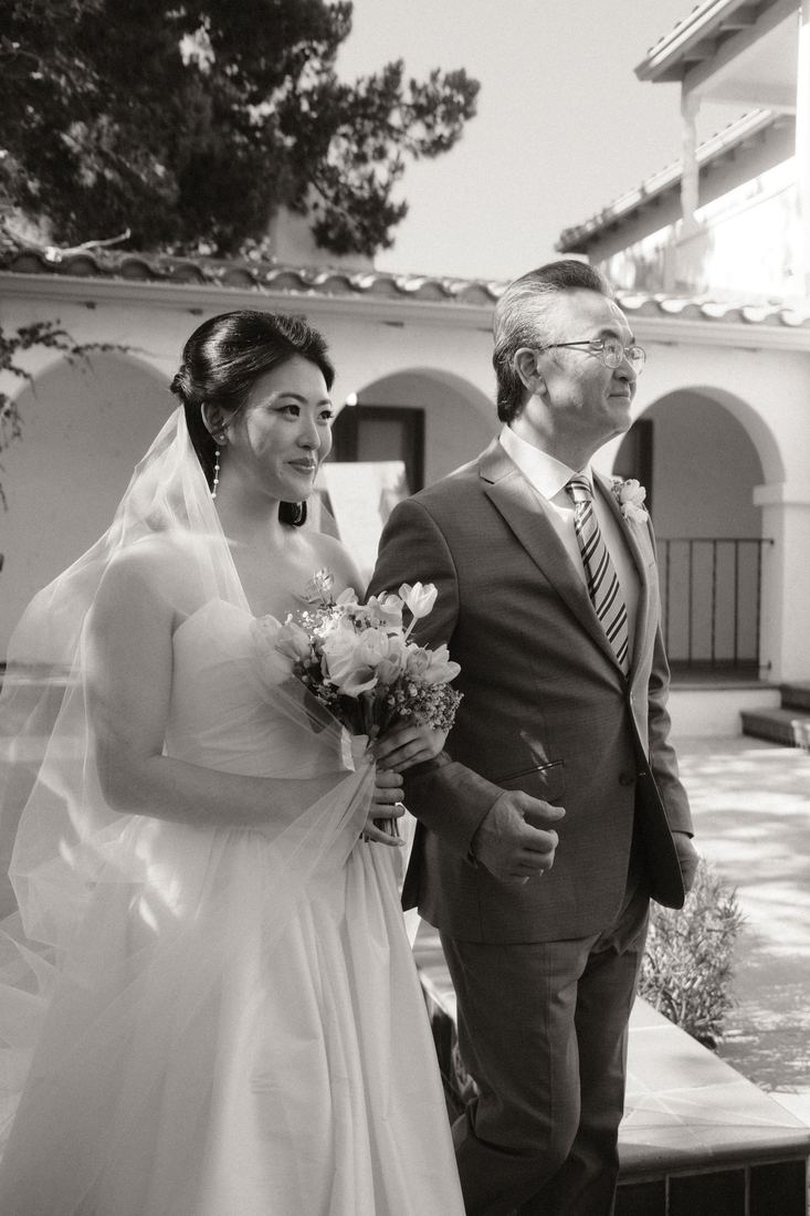 Bride walking with her father, black and white