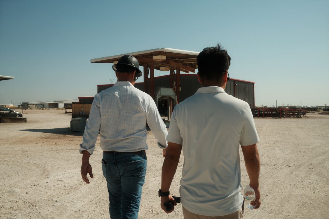 Crew walking across a sunlit yard