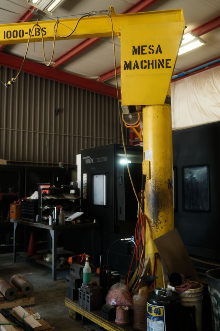 Yellow jib crane on a shop floor